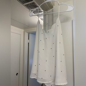 white top with black dots, scallop detail, adjustable racerback strap. medium